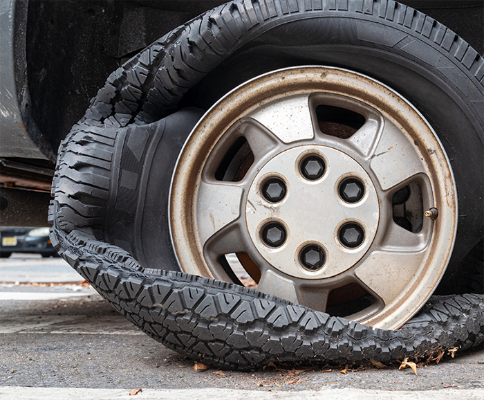 Car tire flattened on street